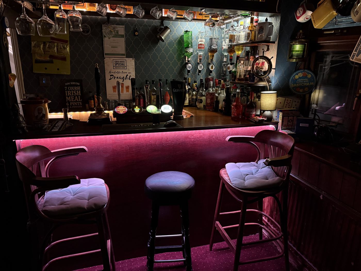 The Inn bar with hanging tankards, beer-mat ceiling, and festive lights