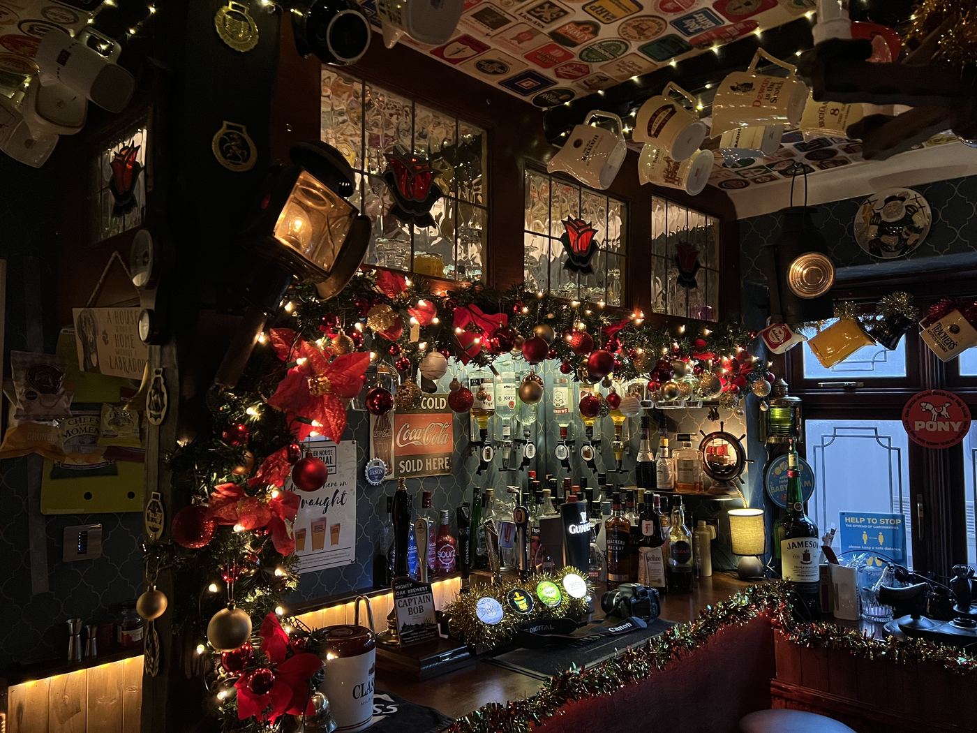 Bar detail with taps, BAR light, and beer-mat ceiling